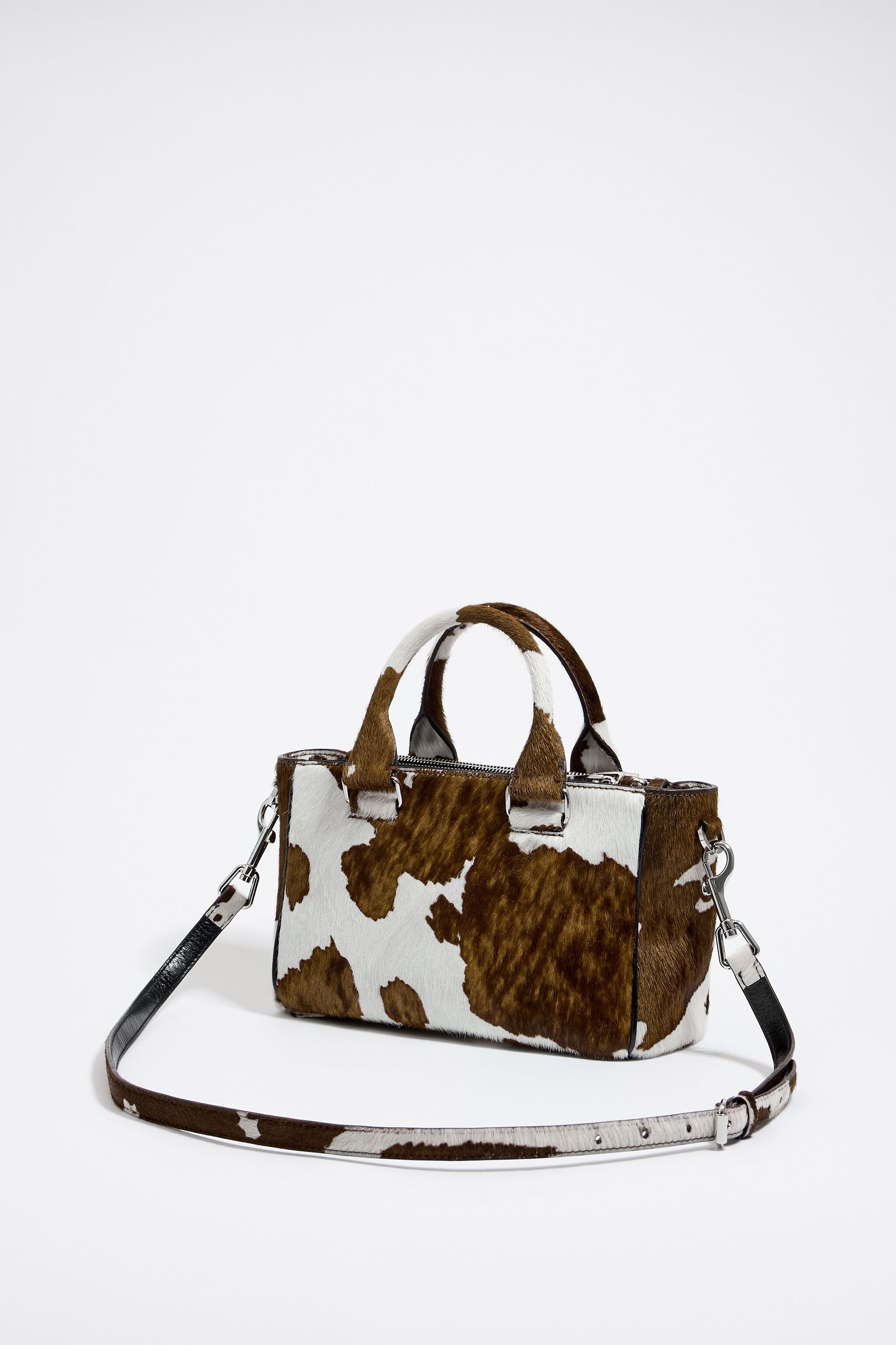 Cow print handbag deals
